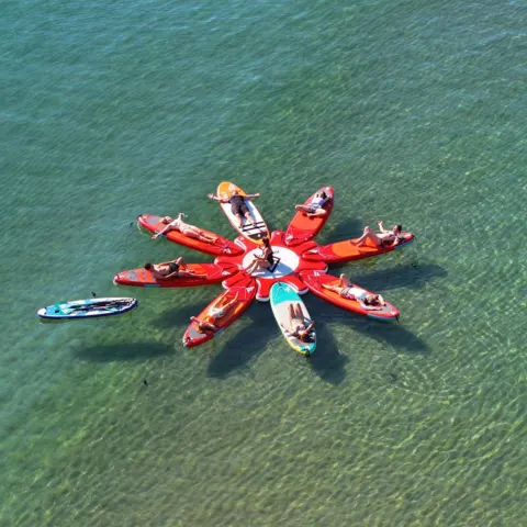 Groupe de stand up paddle vu du ciel