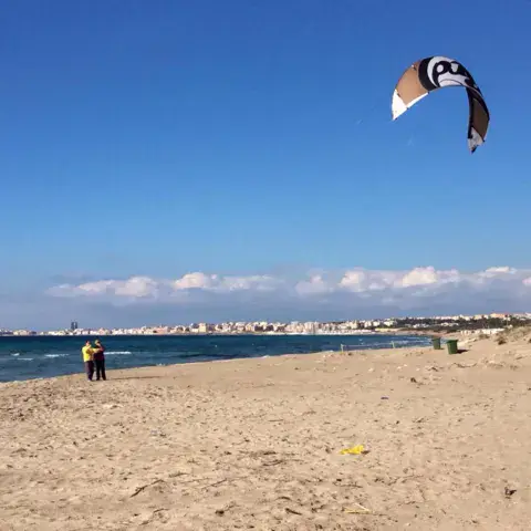 Plage de sable et kite en vol