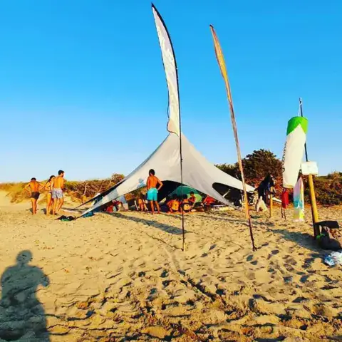 Camp de plage avec voiles et tente