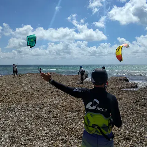 Moniteur IKO guidant le vol du kite depuis la plage
