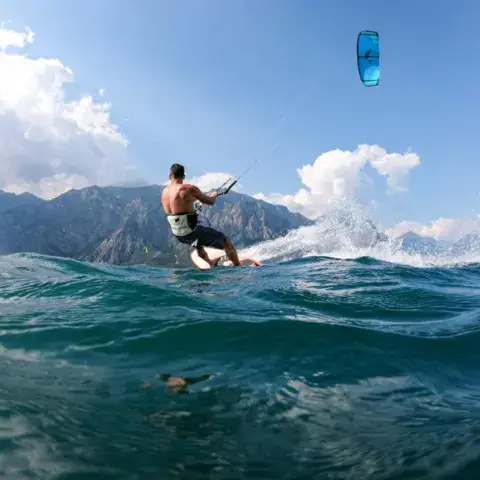 Kitesurfeur sur le lac de Garde, montagnes en arrière-plan