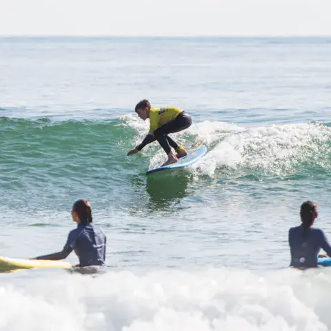 Élèves en cours de surf dans les vagues