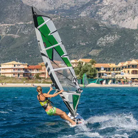 Windsurfeur en navigation devant la côte