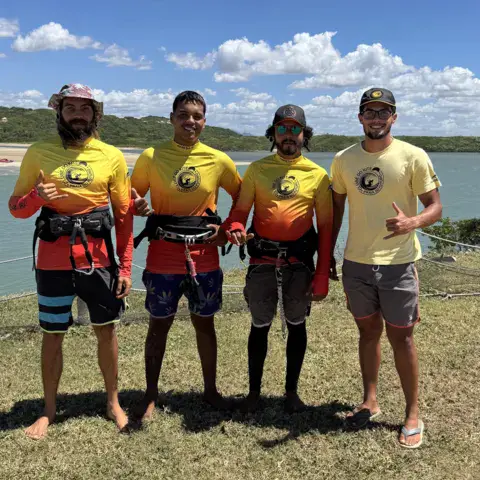 Quatre moniteurs en tee-shirt jaune sur l'herbe