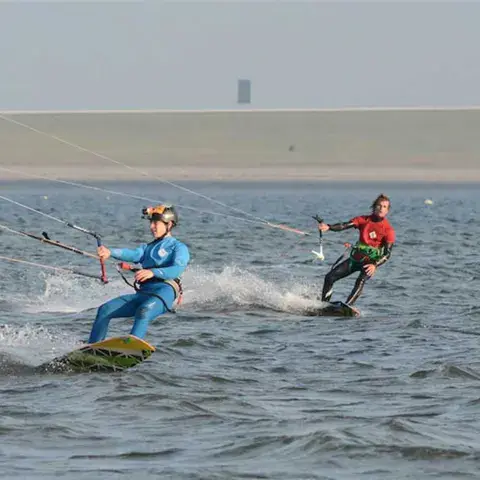 Deux kitesurfeurs sur eau plate