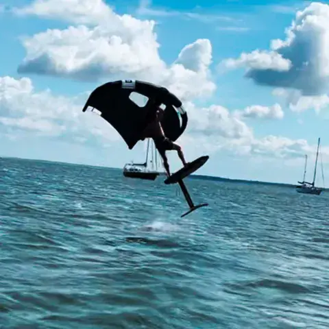 Wingfoiler en vol au-dessus de l'eau