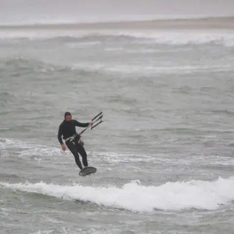 Kitesurfeur en saut sur une mer agitée