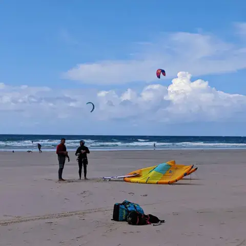 Préparation d'un kite sur la plage avant le cours