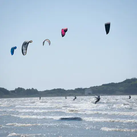 Ailes de kitesurf dans le ciel au-dessus du spot
