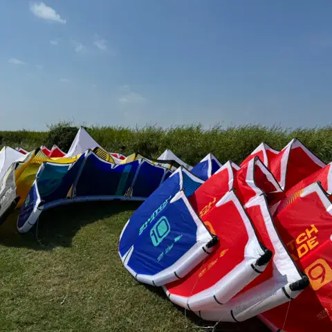 Kites de cours rangés dans l'herbe