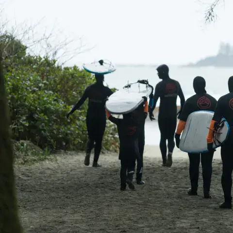 Groupe en combinaison sur le chemin de la plage