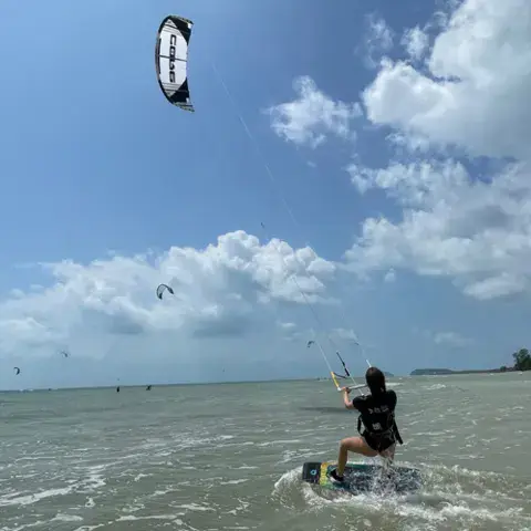 Kitesurfeur sur l'eau, kite en l'air