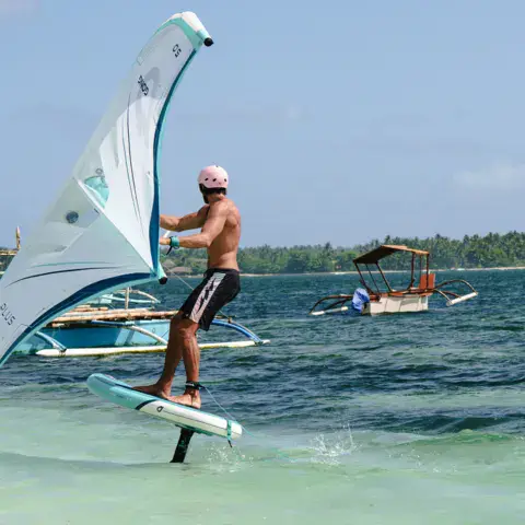 Rider en wing foil près de la côte