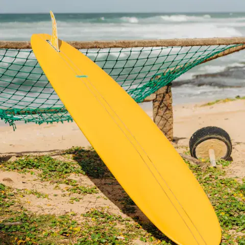Planche jaune posée au bord de la plage