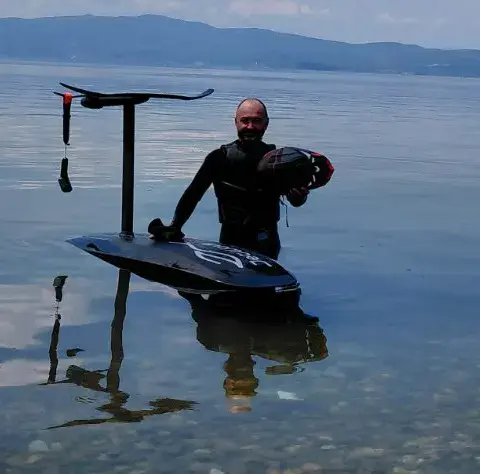 Un eFoil sur le lac, montagnes en arrière-plan