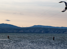 Deux kitesurfeurs sur l'étang en fin de journée