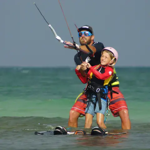 Cours de kitesurf avec un moniteur et un enfant
