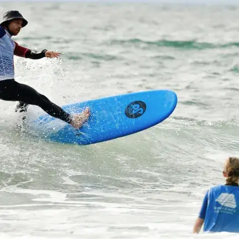 Surfeur en pleine manoeuvre sur une vague