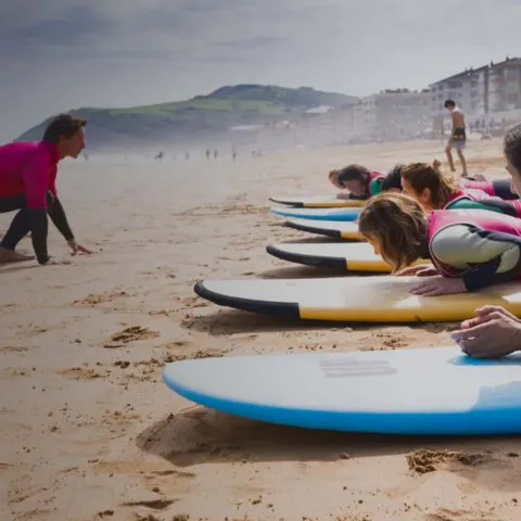 Explications sur le sable avant la séance de surf