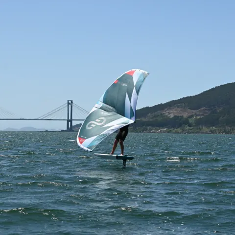 Wingfoil sur la ría, un pont en arrière-plan