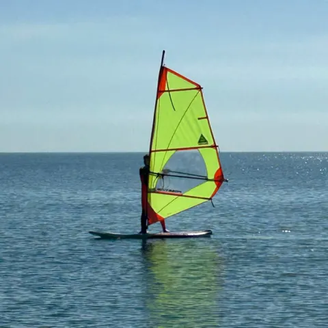 Planche à voile sur une eau calme