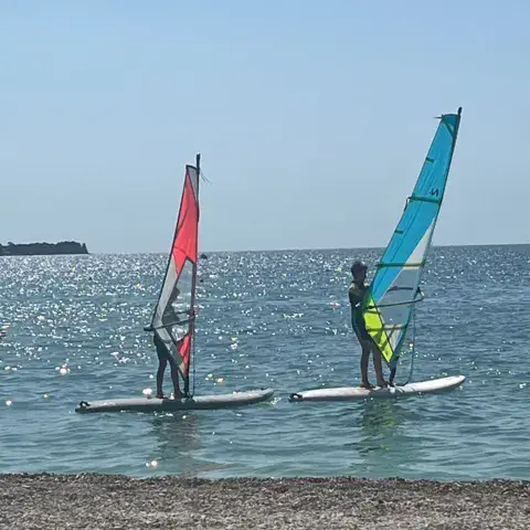 Deux planches à voile sur une eau calme
