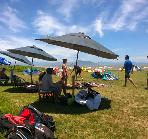 Parasols et matériel sur l'herbe en bord de plage