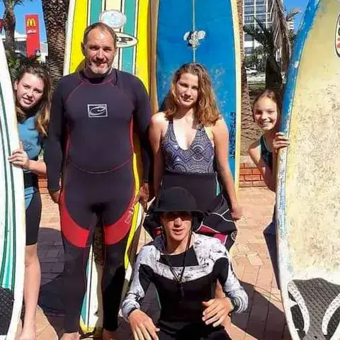 Groupe d'élèves avec leur moniteur et des planches de surf