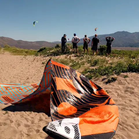 Kite sur la plage, avec des spectateurs au loin