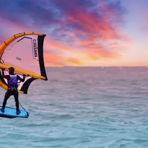 Rider de wing foil au coucher du soleil