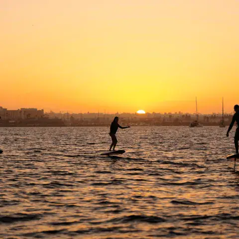 Riders d'eFoil au coucher du soleil