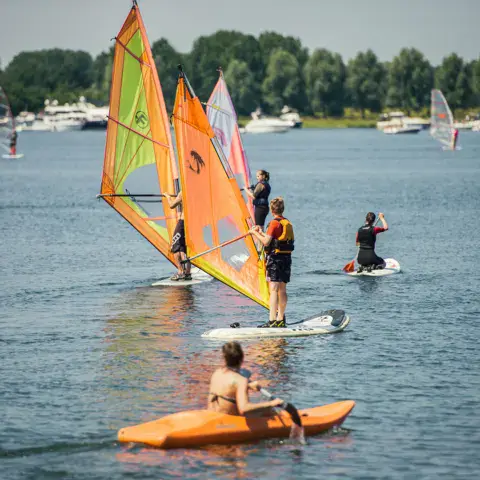 Élèves en windsurf et en kayak sur le lac