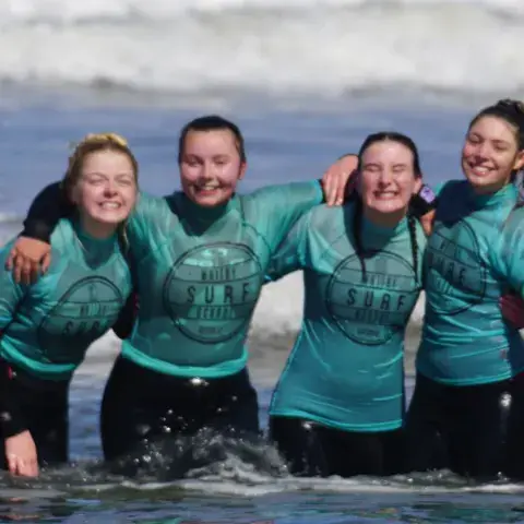 Quatre élèves dans l'eau, en combinaison