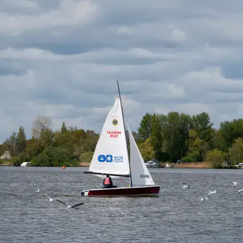 Dériveur à voile blanche sur le lac