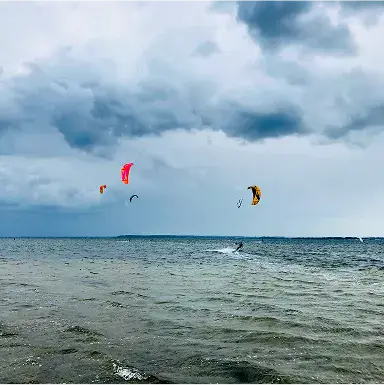 Kitesurfeurs sur la baie par temps nuageux