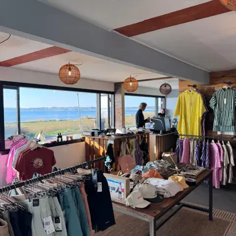 Rayon vêtements du magasin, avec vue sur la baie