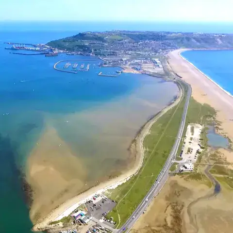 Vue aérienne d'une presqu'île, d'une plage et d'un port