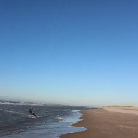 Kitesurfeur sur la mer avec un kite rouge
