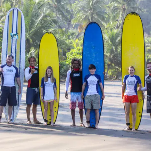 Groupe de surfeurs avec des planches de couleur sur la plage