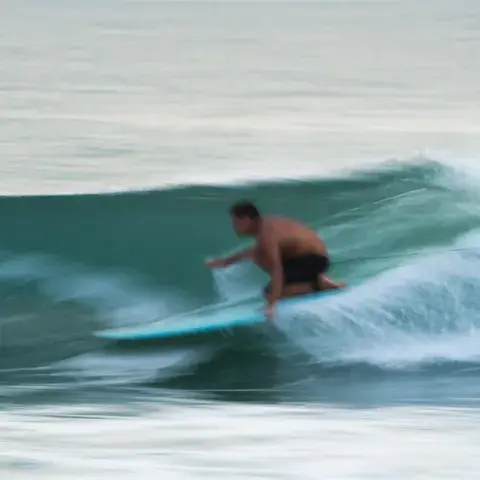 Un surfeur glisse sur une vague