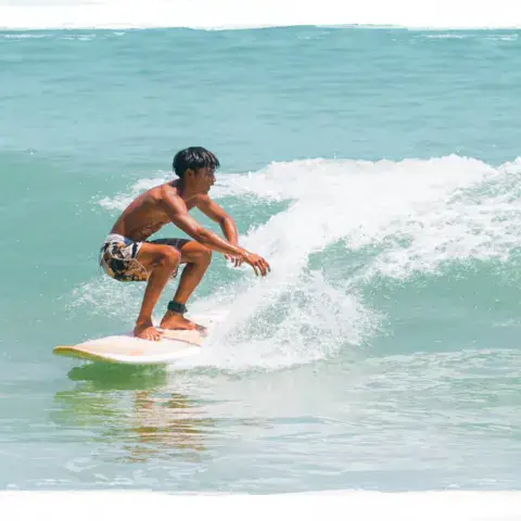 Un jeune surfeur sur une vague