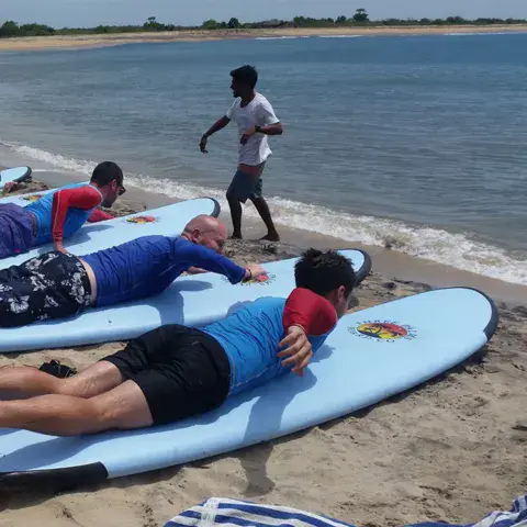 Cours de surf à terre avec un moniteur, sur la plage