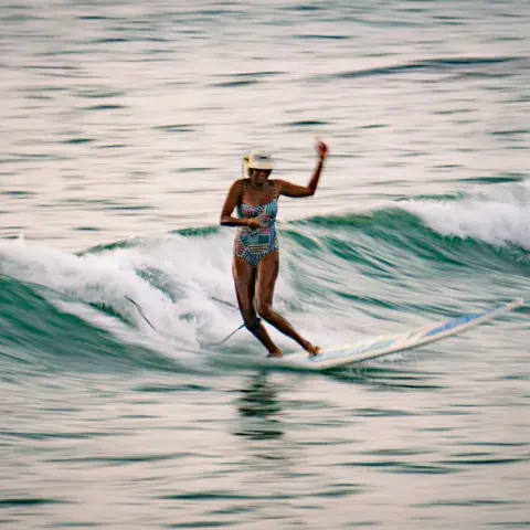 Une surfeuse sur une vague