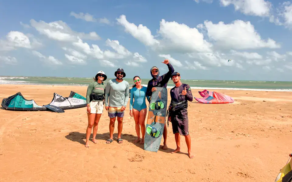Groupe d'élèves et de moniteurs sur la plage avec leur matériel