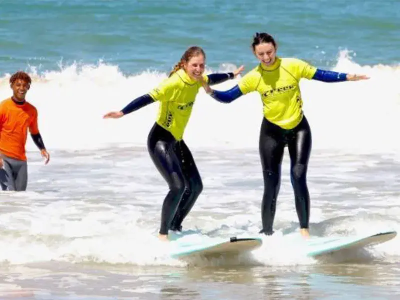 Cours de surf dans les vagues avec un moniteur
