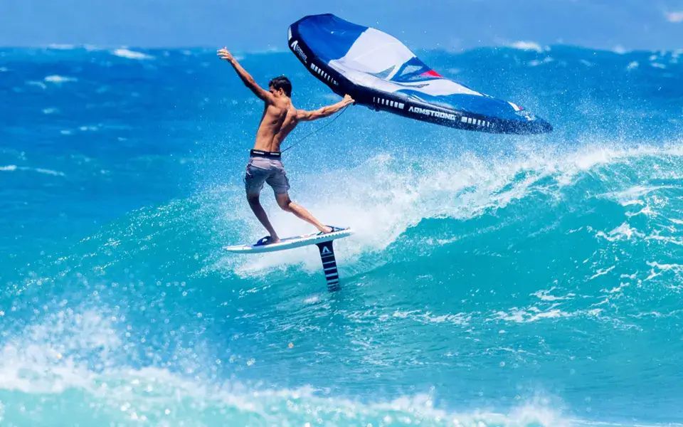 Rider en wing foil sur une vague