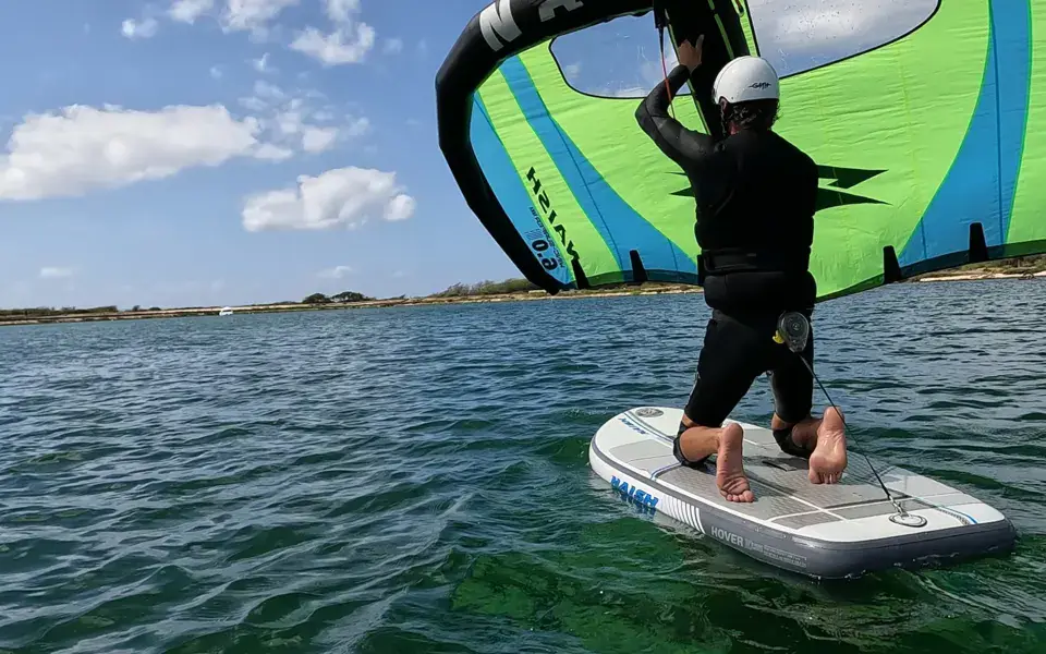 Séance de wing foil sur un plan d'eau abrité