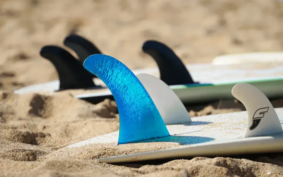 Planches et ailerons posés sur le sable