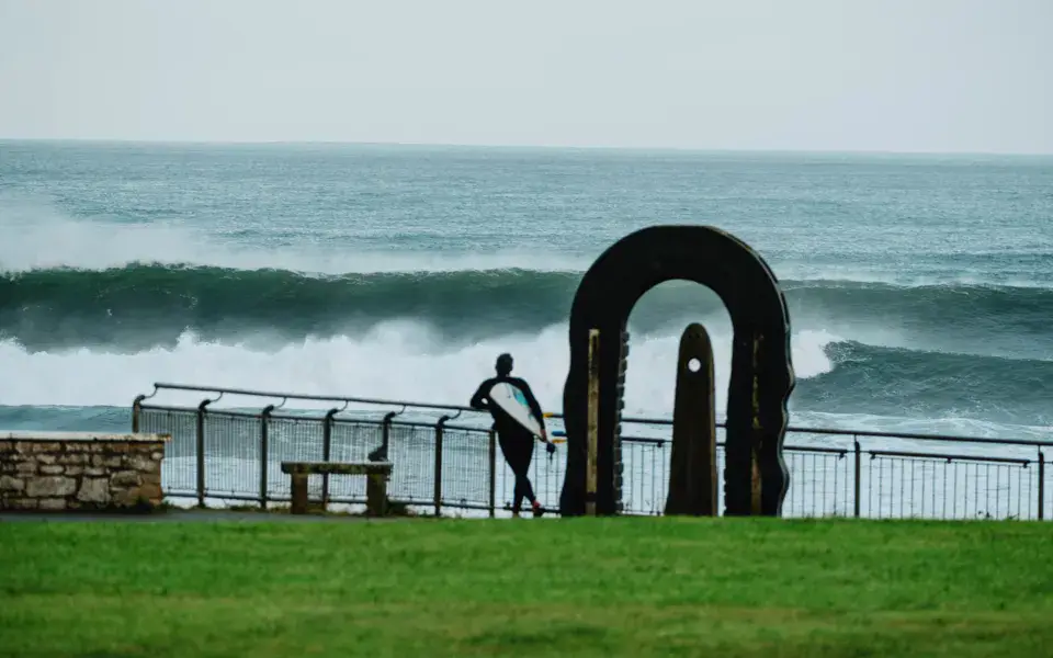Surfeur devant une vague, au bord de la mer
